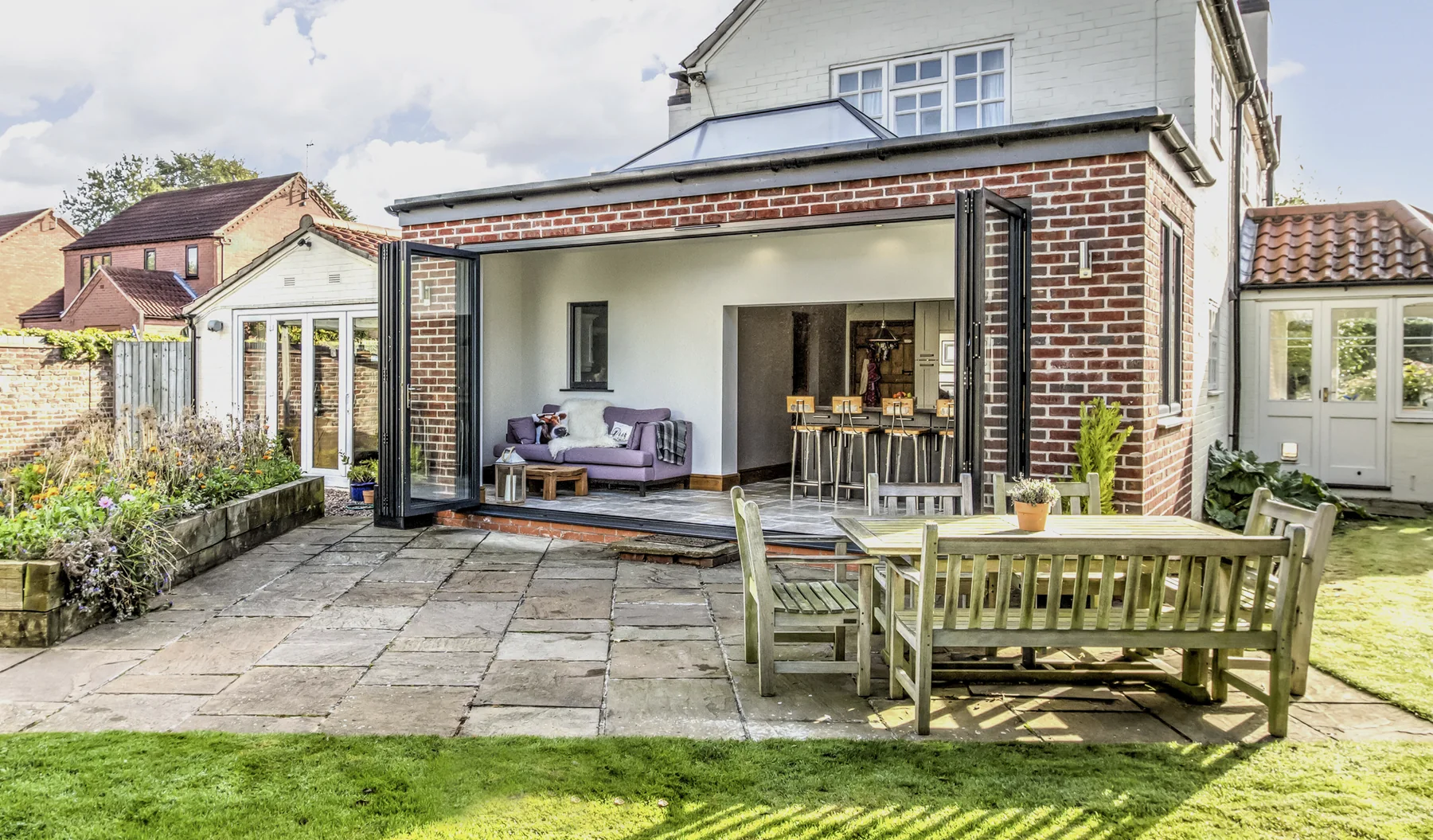 Aluminium bifold doors folded open onto a patio