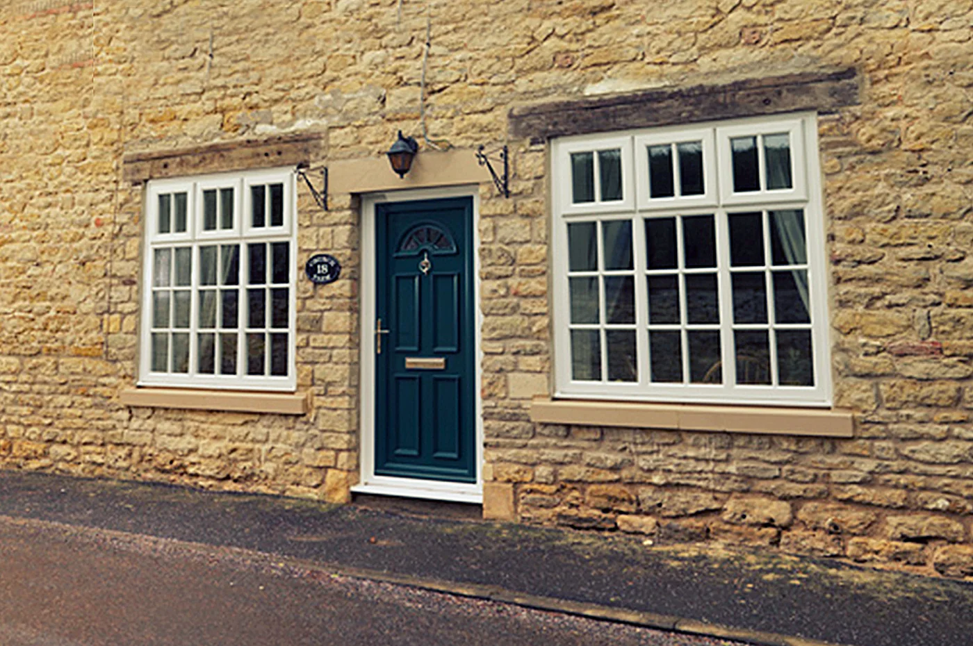 Navy composite front door on a stone cottage