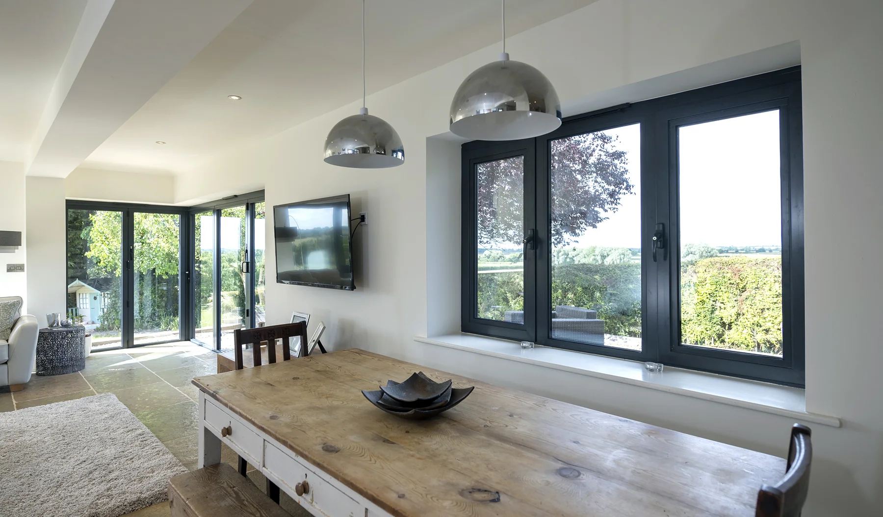 Dining room with dark grey framed windows