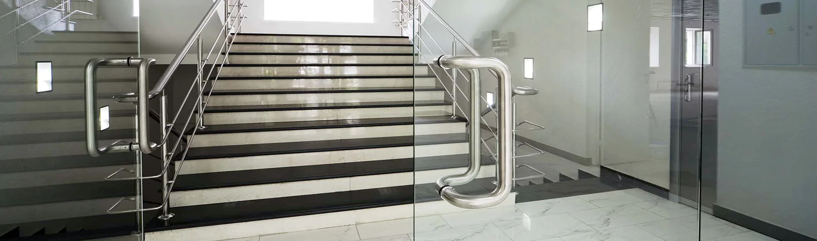 Frameless glass doors and stair balustrade in an office